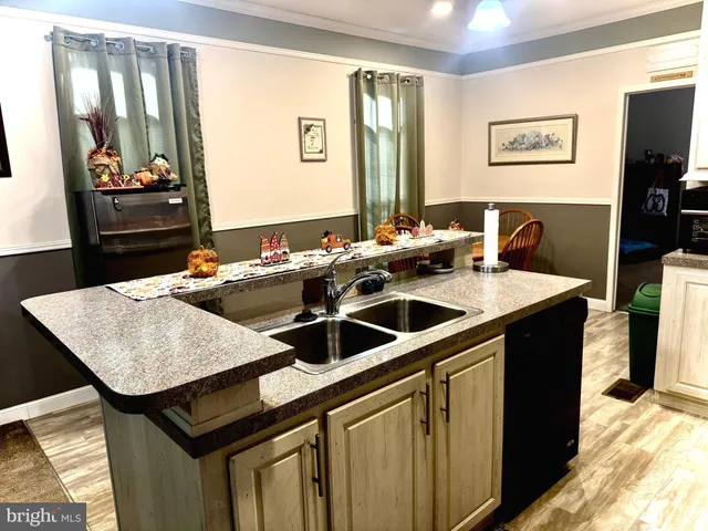 a kitchen with stainless steel appliances granite countertop a refrigerator and a stove