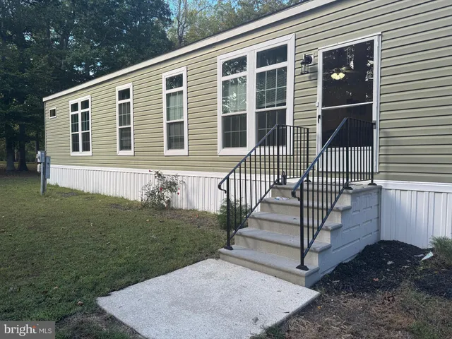 a kitchen with stainless steel appliances kitchen island granite countertop a refrigerator a stove a oven a sink with island and chairs