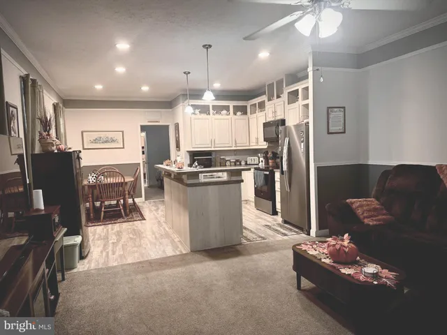 a kitchen with stainless steel appliances granite countertop a refrigerator and a stove