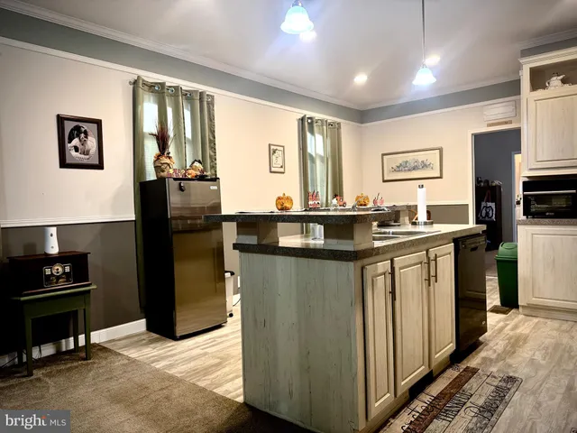 a kitchen with a sink a stove and chairs
