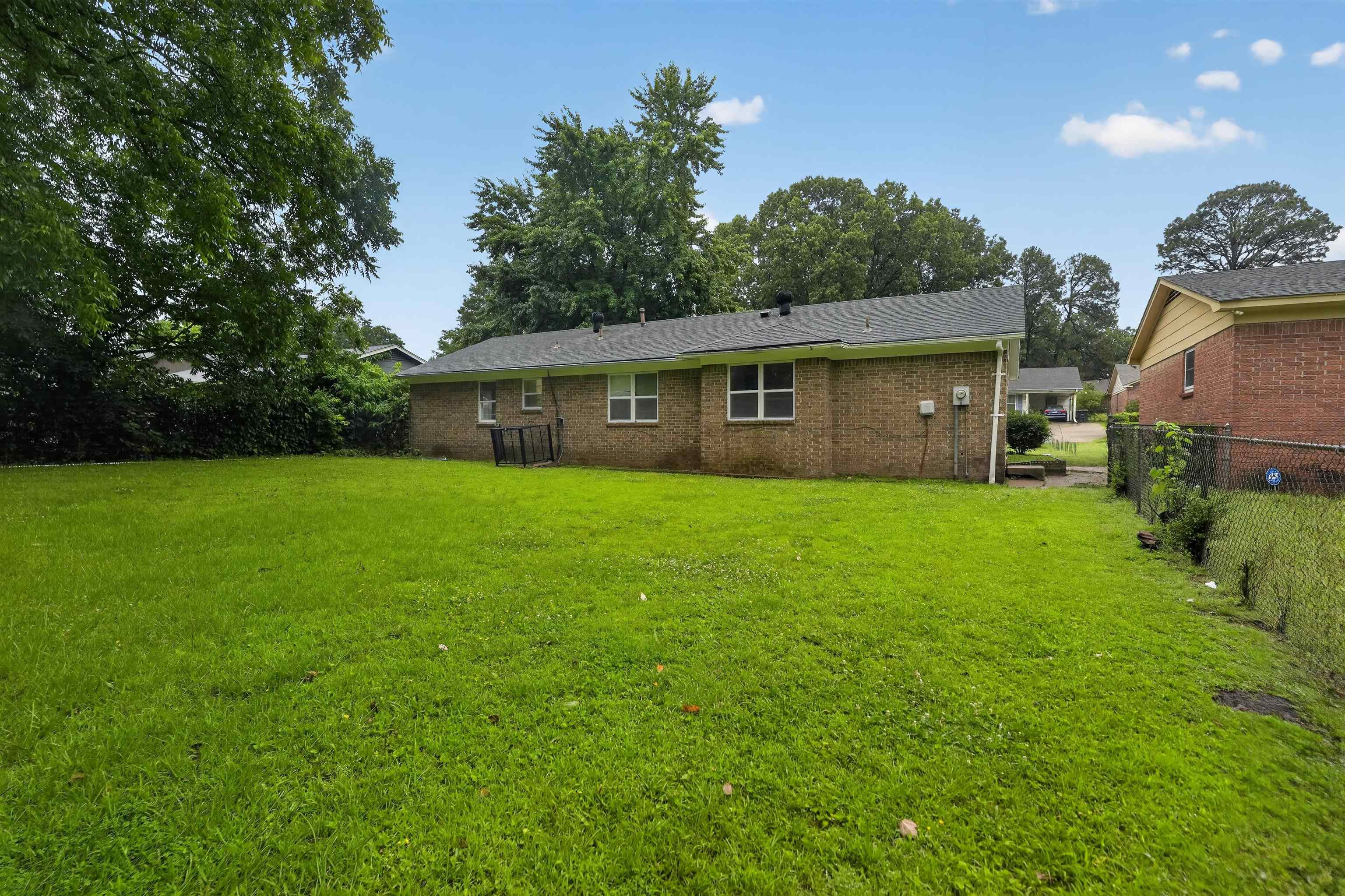 3152 Mackham Avenue Memphis, TN 38118 - Photo 2 of 16 Expansive green lawn with mature trees bordering the property