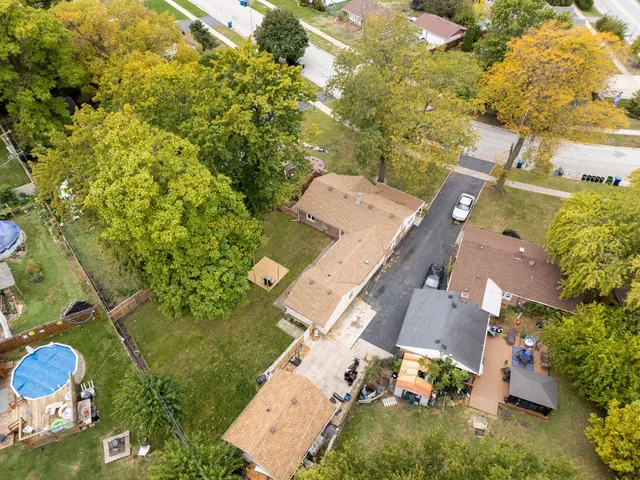 an aerial view of a house with yard swimming pool and outdoor seating