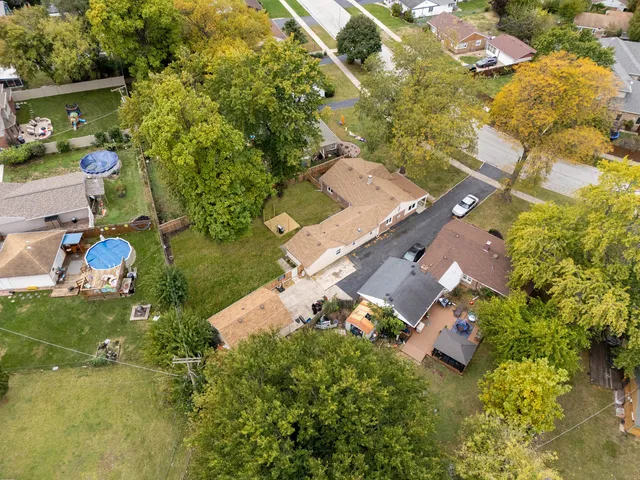 an aerial view of a house with a yard basket ball court and outdoor seating