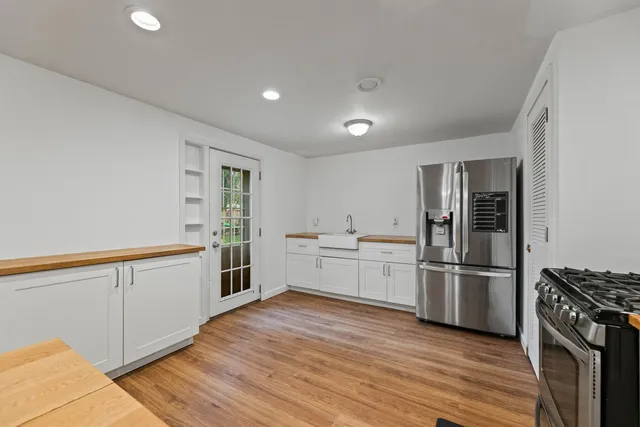 a kitchen with a refrigerator and a stove top oven