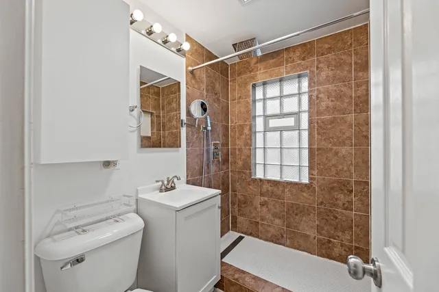 a bathroom with a sink toilet and shower
