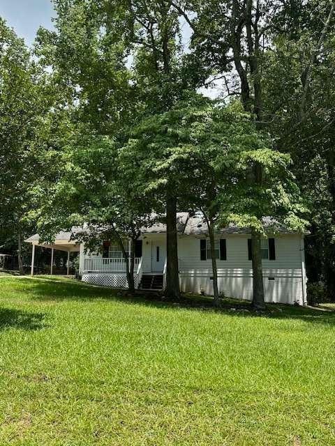 a front view of house with yard and green space