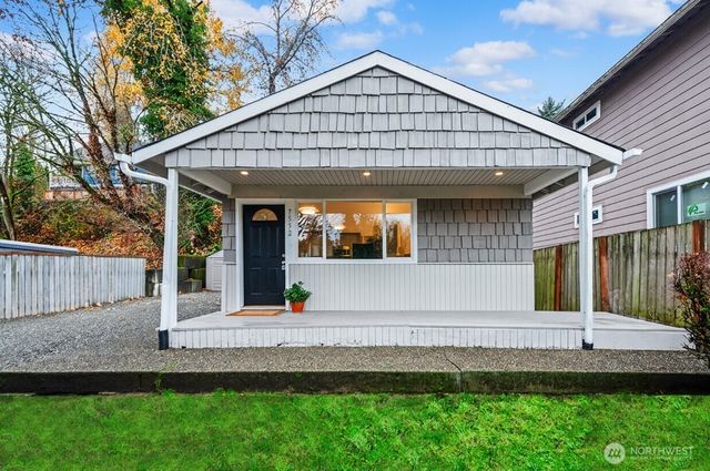 a view of small house with wooden fence