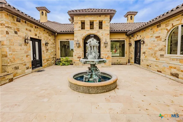 a front view of a house with a garden and patio