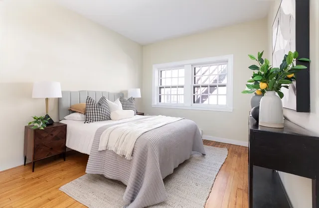 a bedroom with a bed and a potted plant