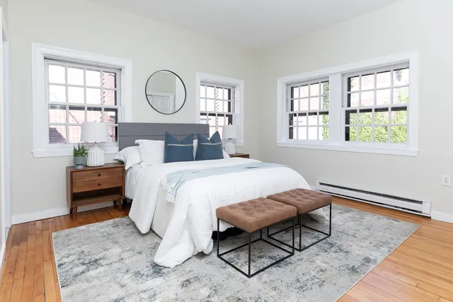 a bed sitting in a bedroom next to a window