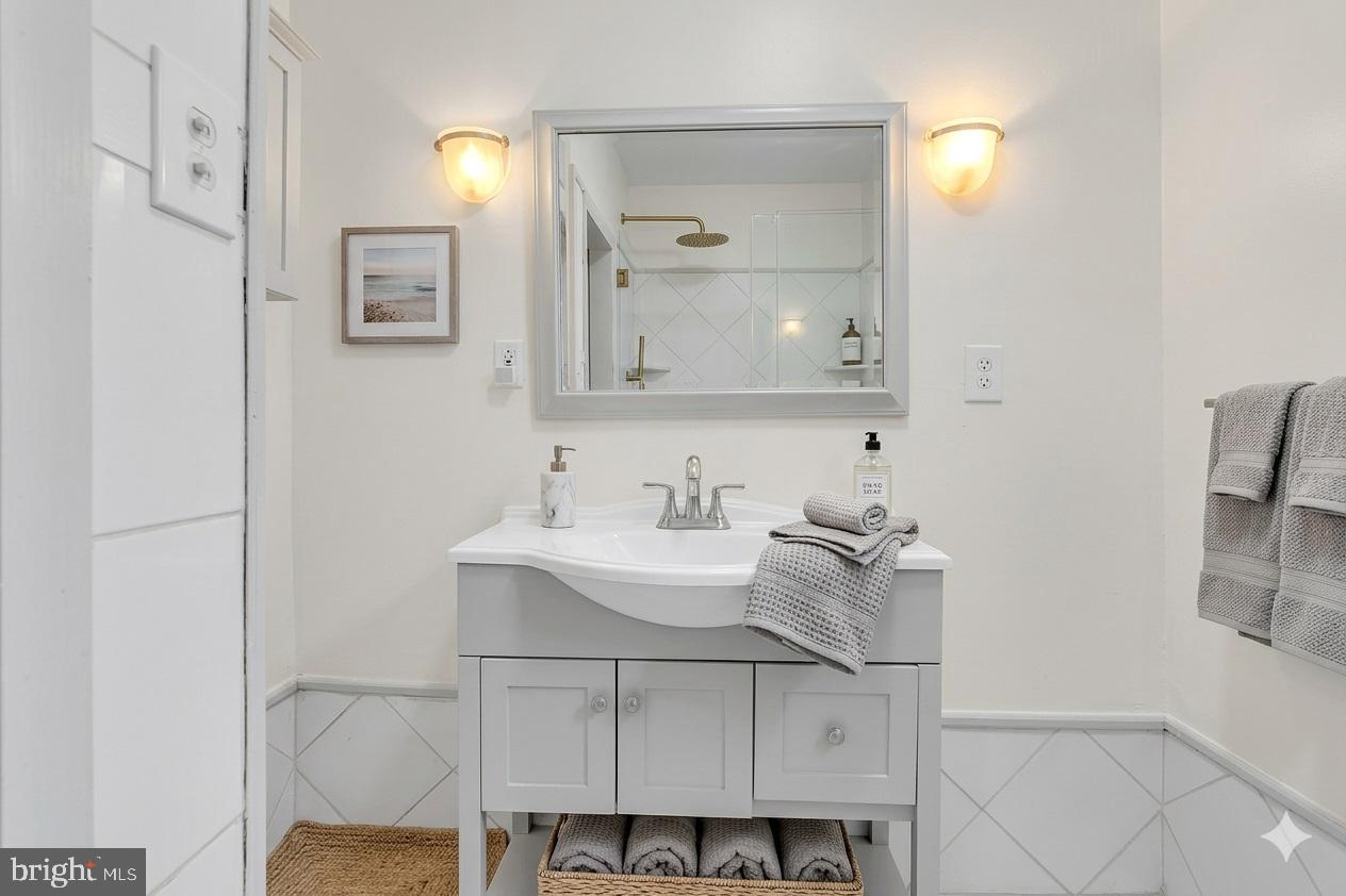 1419 Ellsworth Street Philadelphia, PA 19146 - Photo 12 of 17 a bathroom with a sink and a mirror