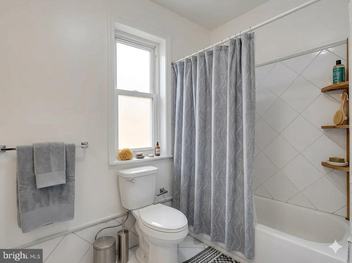 1419 Ellsworth Street Philadelphia, PA 19146 - Photo 14 of 17 a bathroom with a toilet a sink and a bathtub