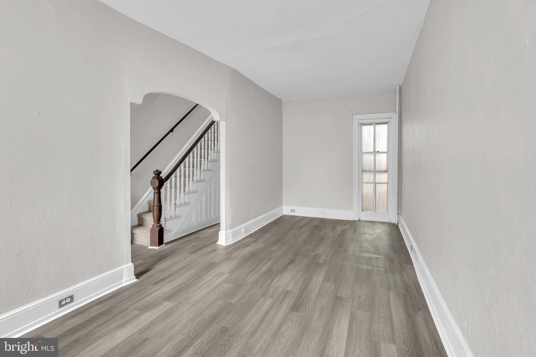 1419 Ellsworth Street Philadelphia, PA 19146 - Photo 5 of 17 an empty room with wooden floor and windows
