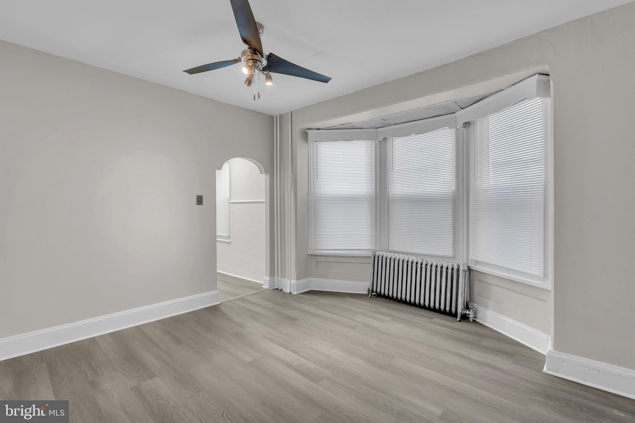 1419 Ellsworth Street Philadelphia, PA 19146 - Photo 6 of 17 wooden floor in an empty room with a window