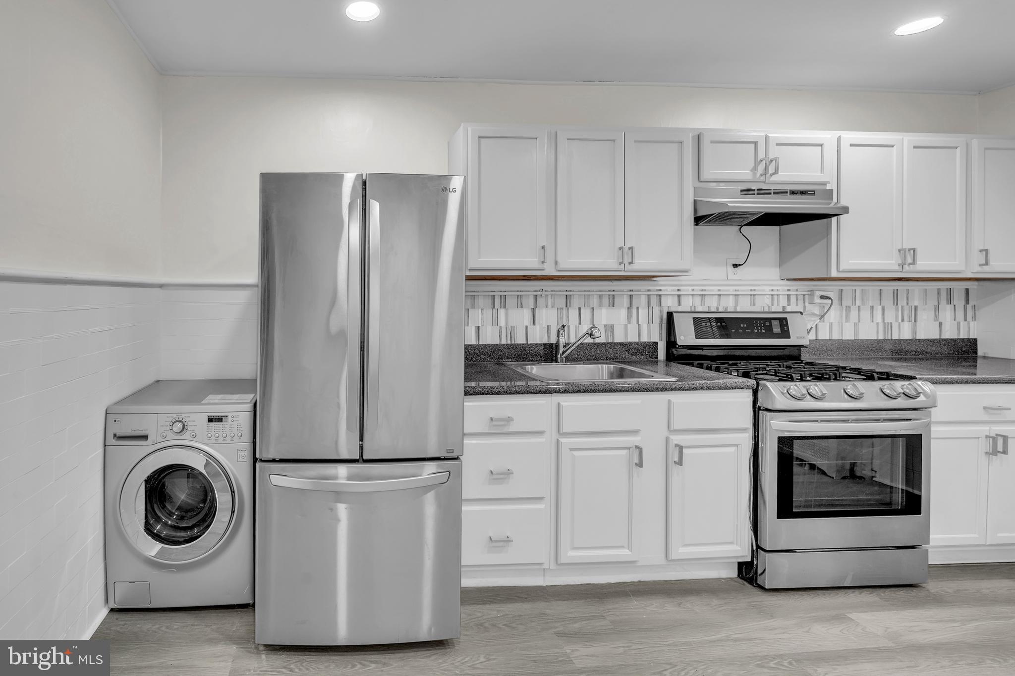 1419 Ellsworth Street Philadelphia, PA 19146 - Photo 8 of 17 a kitchen with cabinets and stainless steel appliances