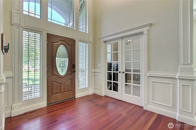 an empty room with wooden floor and door
