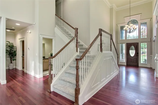 a view of entryway and hall with wooden floor