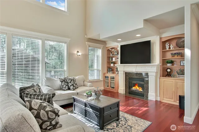a living room with furniture a flat screen tv and a fireplace
