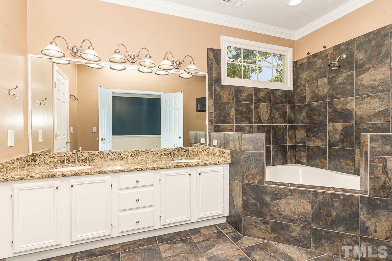 2909 Englefield Drive Raleigh, NC 27615 - Photo 24 of 31 a bathroom with a granite countertop sink mirror and