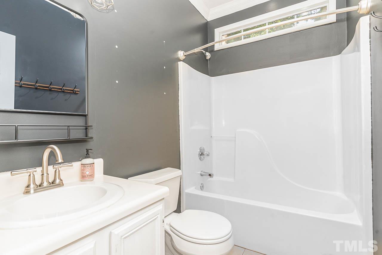 2909 Englefield Drive Raleigh, NC 27615 - Photo 30 of 31 a bathroom with a sink a toilet and shower