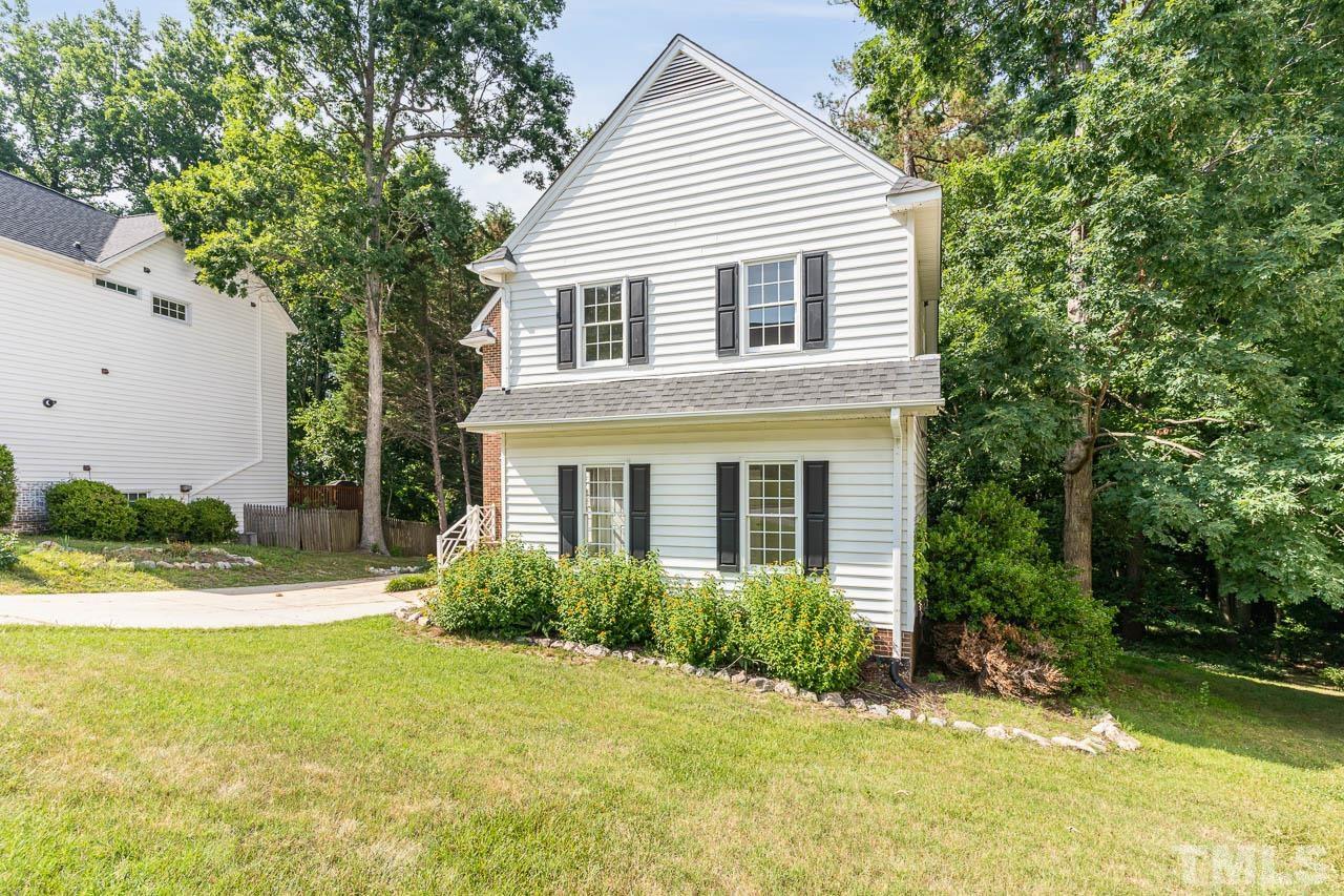 2909 Englefield Drive Raleigh, NC 27615 - Photo 3 of 31 a view of a house with a yard plants and large tree
