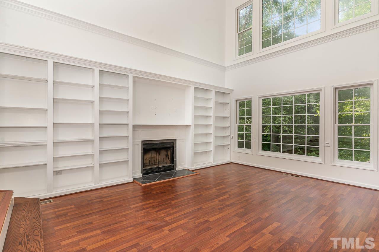 2909 Englefield Drive Raleigh, NC 27615 - Photo 10 of 31 a view of an empty room with a window and wooden floor