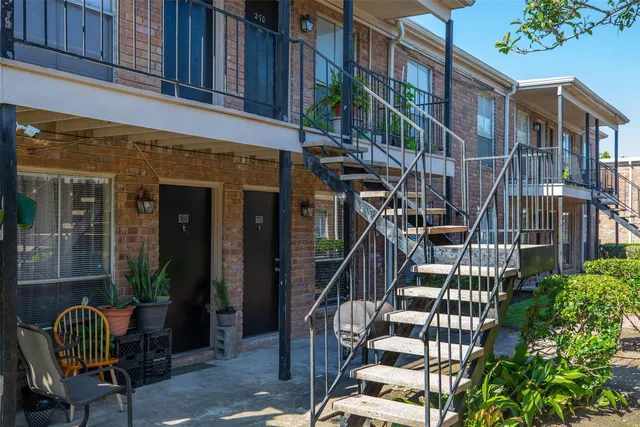 a view of a brick building with a potted plant