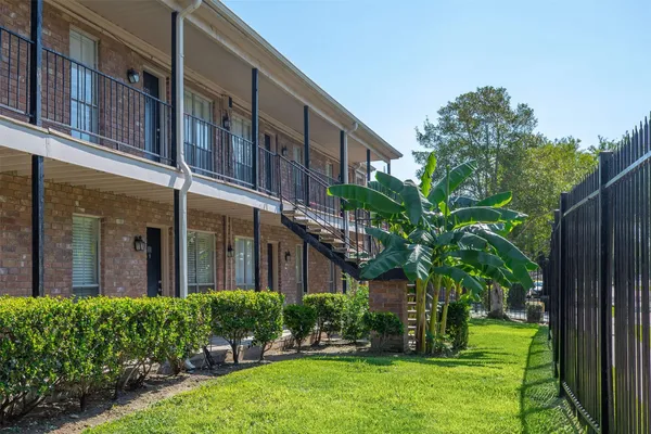 a house view with swimming pool and garden space