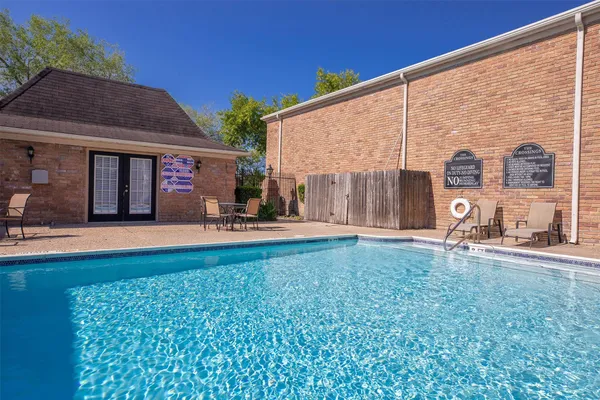swimming pool view with a seating space and a garden view