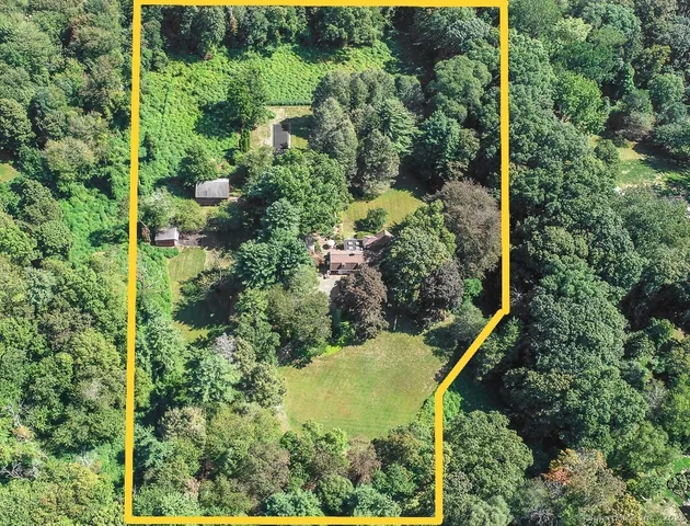 an aerial view of residential house with an outdoor space and seating