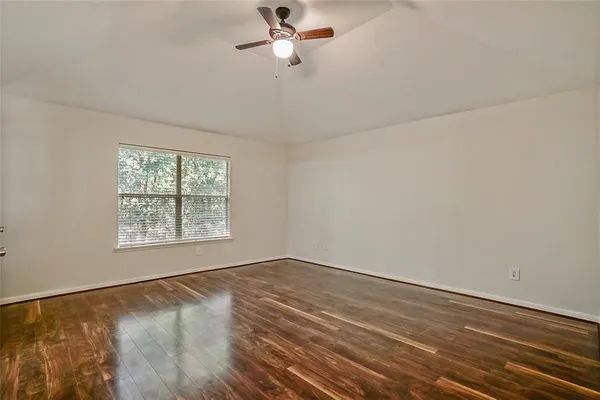 wooden floor in an empty room with a window