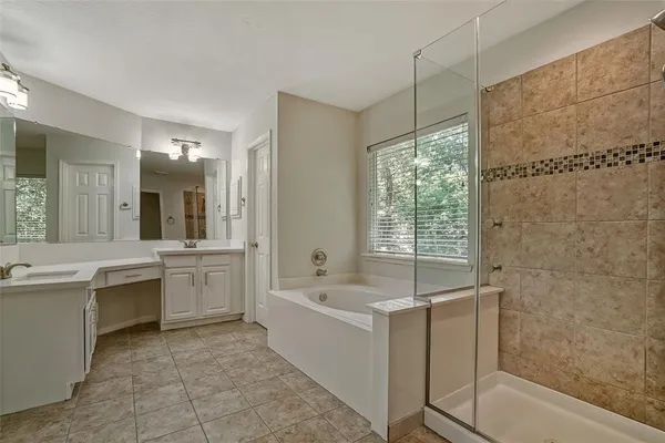 a bathroom with a tub sink and mirror