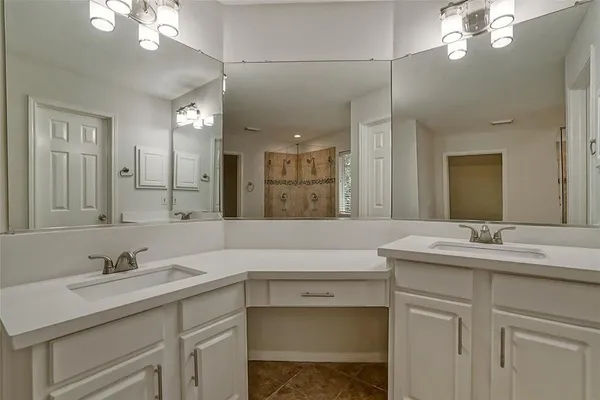 a bathroom with a sink vanity and a mirror
