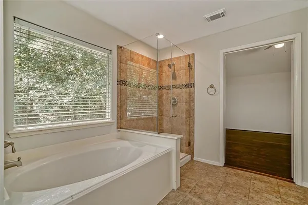 a bathroom with a bathtub and a shower