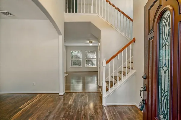 a view of entryway with wooden floor and stairs