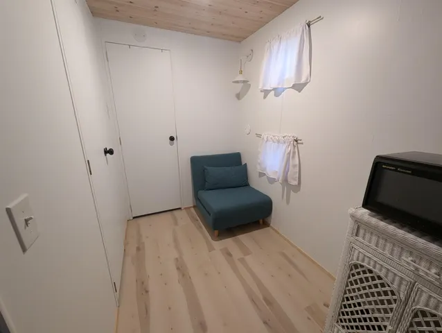 a bedroom with a bed and a chair