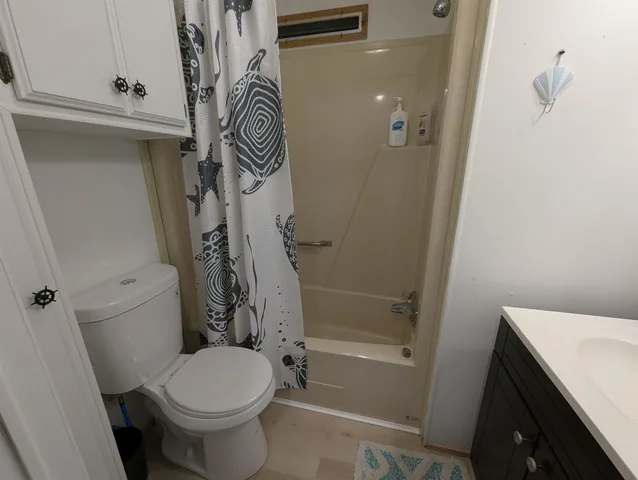 a bathroom with a toilet and a shower