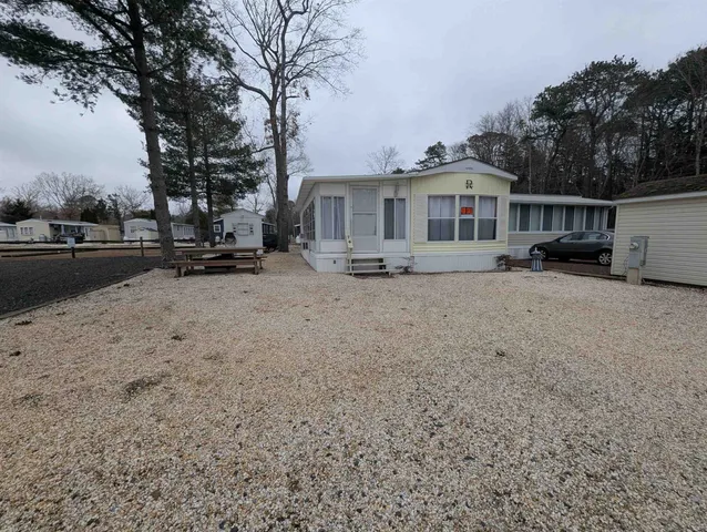 a view of a house with a yard covered in snow