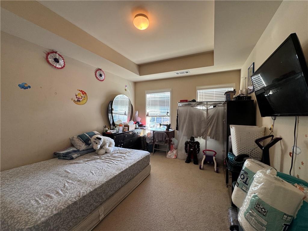 805 Pleasant Hill Road, Unit 333 Lilburn, GA 30047 - Photo 11 of 22 a living room with furniture and a flat screen tv