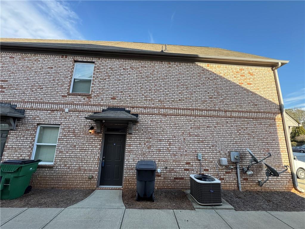 805 Pleasant Hill Road, Unit 333 Lilburn, GA 30047 - Photo 17 of 22 a front view of a house with outdoor seating