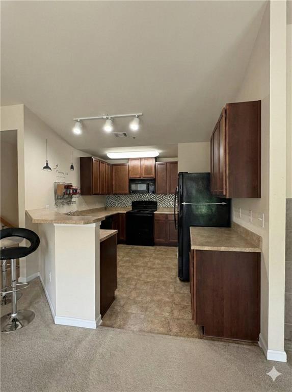 805 Pleasant Hill Road, Unit 333 Lilburn, GA 30047 - Photo 2 of 22 a kitchen with stainless steel appliances kitchen island granite countertop a refrigerator and a stove top oven