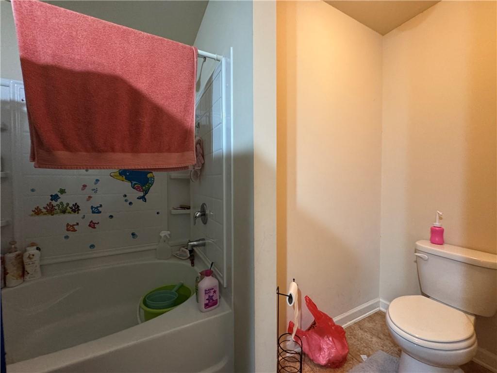 805 Pleasant Hill Road, Unit 333 Lilburn, GA 30047 - Photo 10 of 22 a bathroom with a toilet and a bathtub
