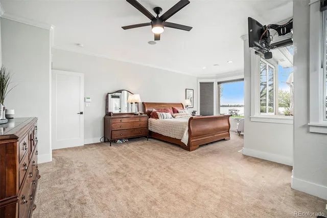 a spacious bedroom with a bed and ceiling fan
