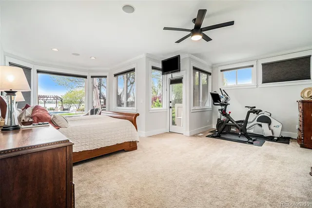 a bedroom with furniture and a large window