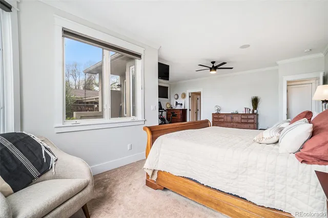 a bedroom with a bed couch and a window
