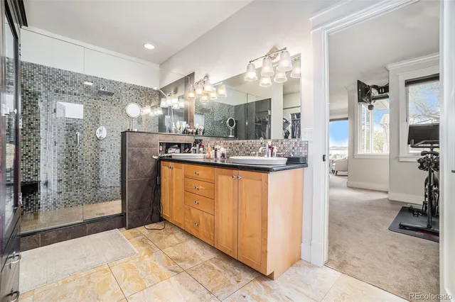 a bathroom with a sink a mirror and a shower