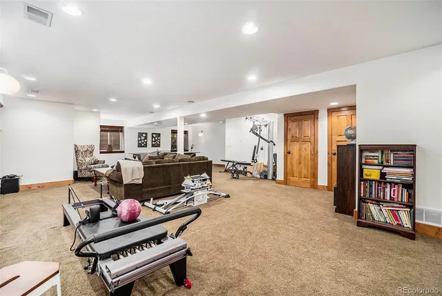 a living room with furniture a table and a bookshelf