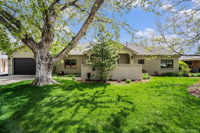a yellow house in middle of the grass
