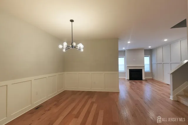 a view of a room with wooden floor and ceiling fan