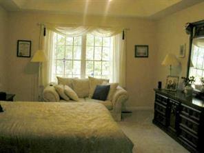 497 Kemp Road Mooresville, NC 28117 - Photo 5 of 8 a bed sitting in a bedroom next to a window